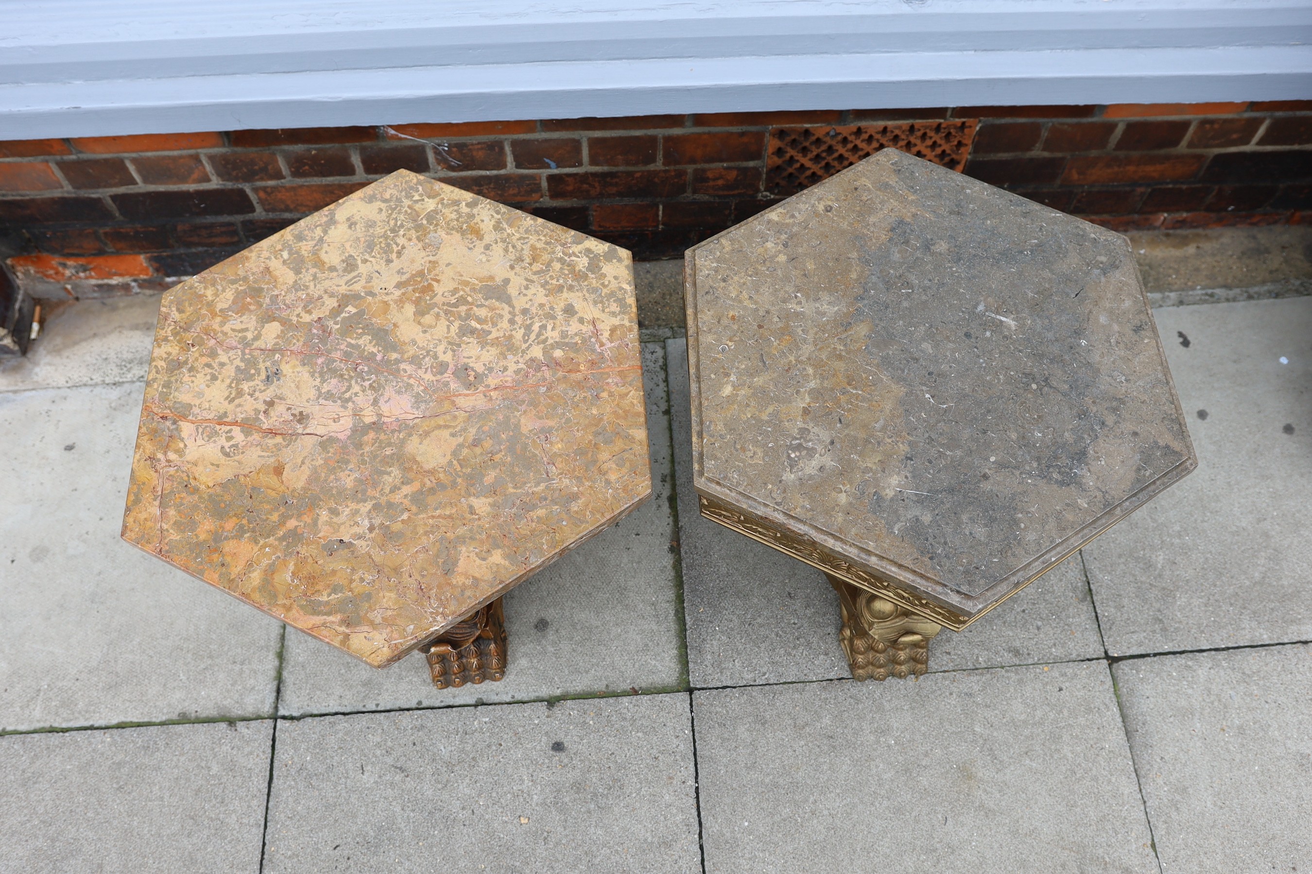 A near pair of 1960’s Italian carved giltwood occasional tables, with hexagonal marble tops and stylised dolphin underframes, height 48cm. width 66cm